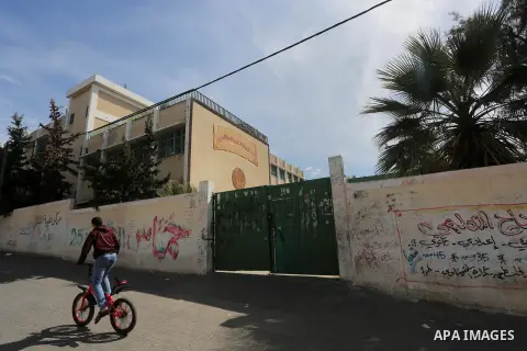 A Palestinian boy walks past a closed school during the strike of the employees of former Palestinian government in Gaza Strip and West bank to demand for pay their salaries, in Gaza city on February 25, 2016. Photo by M...
