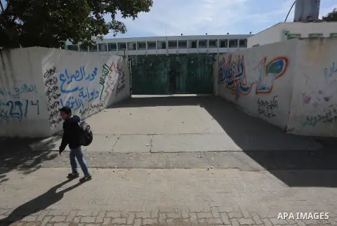 A Palestinian boy walks past a closed school during the strike of the employees of former Palestinian government in Gaza Strip and West bank to demand for pay their salaries, in Gaza city on February 25, 2016. Photo by M...