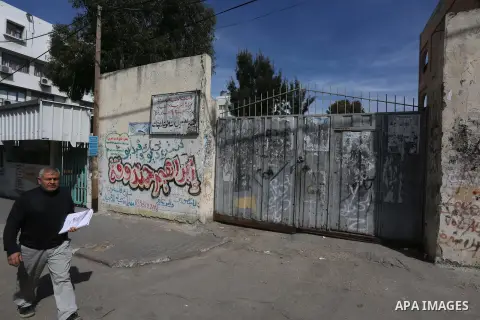 A Palestinian man walks past a closed school during the strike of the employees of former Palestinian government in Gaza Strip and West bank to demand for pay their salaries, in Gaza city on February 25, 2016. Photo by M...