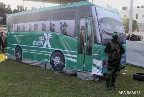 Palestinian militants of the Ezzedine al-Qassam Brigades, the armed wing of the Hamas movement, take part in an anti-Israel rally on February 26, 2016, in the southern Gaza Strip town of Rafah. Photo by Abed Rahim Khatib