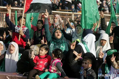 Palestinian supporters of the Hamas islamist movement shout slogans during an anti-Israel rally on February 26, 2016, in the southern Gaza Strip town of Rafah. Photo by Abed Rahim Khatib