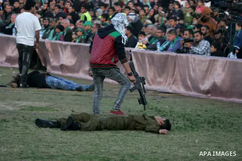 Palestinian boys simulate an attack during a show as part of an anti-Israel rally on February 26, 2016, in the southern Gaza Strip town of Rafah. Photo by Abed Rahim Khatib
