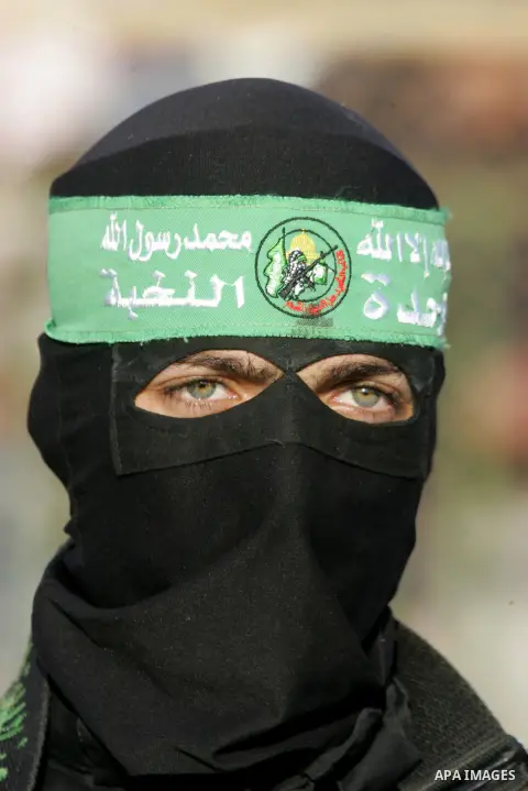 Palestinian militants of the Ezzedine al-Qassam Brigades, the armed wing of the Hamas movement, take part in an anti-Israel rally on February 26, 2016, in the southern Gaza Strip town of Rafah. Photo by Abed Rahim Khatib