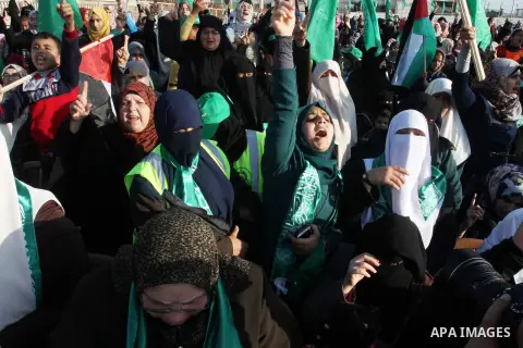 Palestinian supporters of the Hamas islamist movement shout slogans during an anti-Israel rally on February 26, 2016, in the southern Gaza Strip town of Rafah. Photo by Abed Rahim Khatib