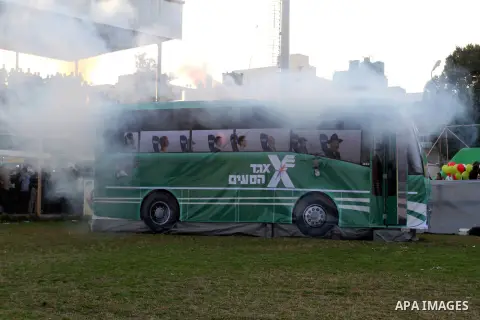 A mock Israeli bus is seen on fire during a show as part of an anti-Israel rally on February 26, 2016, in the southern Gaza Strip town of Rafah. Photo by Abed Rahim Khatib