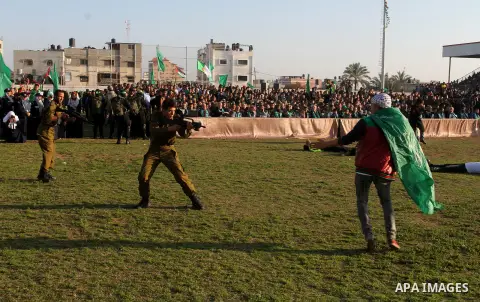 Palestinian boys simulate an attack during a show as part of an anti-Israel rally on February 26, 2016, in the southern Gaza Strip town of Rafah. Photo by Abed Rahim Khatib