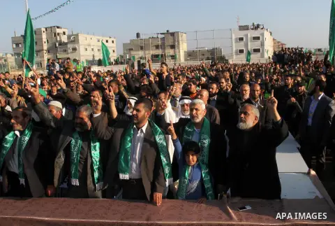 Palestinian supporters of the Hamas islamist movement shout slogans during an anti-Israel rally on February 26, 2016, in the southern Gaza Strip town of Rafah. Photo by Abed Rahim Khatib