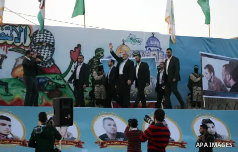 Palestinian islamist movement Hamas' chief, Ismail Haniya waves to the crowd during an anti-Israel rally on February 26, 2016, in the southern Gaza Strip town of Rafah. Photo by Abed Rahim Khatib