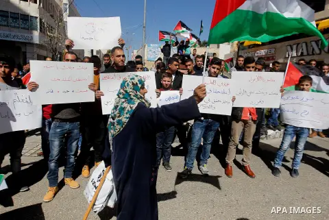 Palestinian school students take part during a protest to show solidarity with Palestinian teachers in their strike wihch entered its 16th consecutive day to call Palestinian Authority to demand their rights in the West...