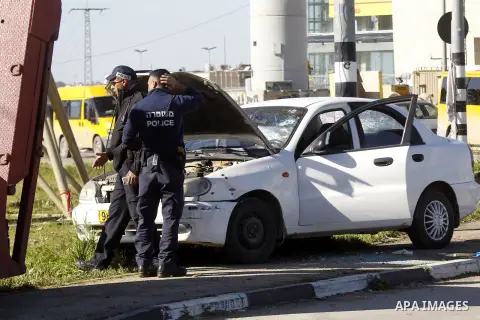 Israeli security forces inspect a car used by a Palestinian woman who, the Israeli military said, rammed it into an Israeli soldier before she was shot dead by the Israeli troops, at a main junction near the Israeli sett...