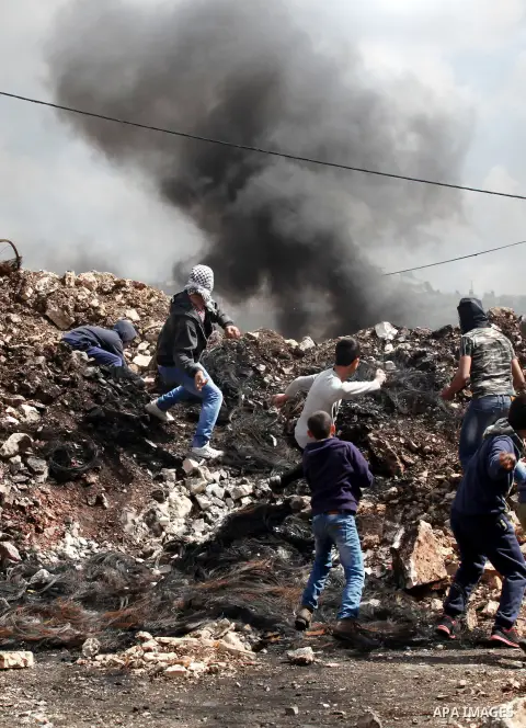 Palestinian protesters hurl stones towards Israeli security forces during clashes following a demonstration against the expropriation of Palestinian land by Israel in the village of Kfar Qaddum, near Nablus, in the occup...