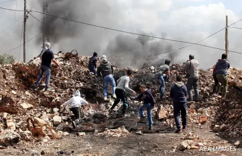 Palestinian protesters hurl stones towards Israeli security forces during clashes following a demonstration against the expropriation of Palestinian land by Israel in the village of Kfar Qaddum, near Nablus, in the occup...