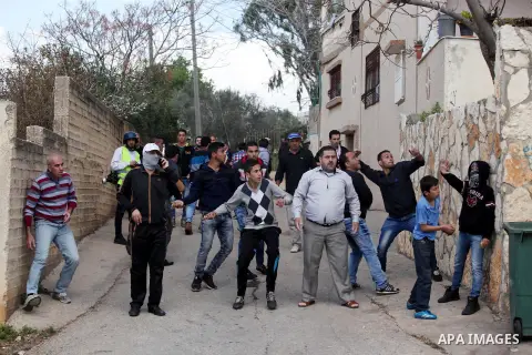Palestinian protesters hurl stones towards Israeli security forces during clashes following a demonstration against the expropriation of Palestinian land by Israel in the village of Kfar Qaddum, near Nablus, in the occup...