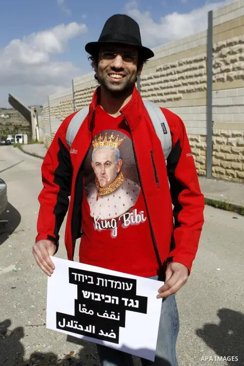 Peace activist take part during a joint Israeli-Palestinian peace march along the Israeli controvertial separation wall in the West Bank city of Beit Jala between Bethlehem and Jerusalem, on March 4, 2016. Peace activist...