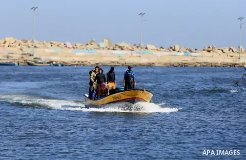 Palestinian fishermen ride their fishing at Gaza's seaport of Gaza City, on March 5, 2016. Photo by Yasser Qudih