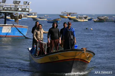 Palestinian fishermen ride their fishing at Gaza's seaport of Gaza City, on March 5, 2016. Photo by Yasser Qudih