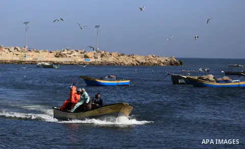Palestinian fishermen ride their fishing at Gaza's seaport of Gaza City, on March 5, 2016. Photo by Yasser Qudih