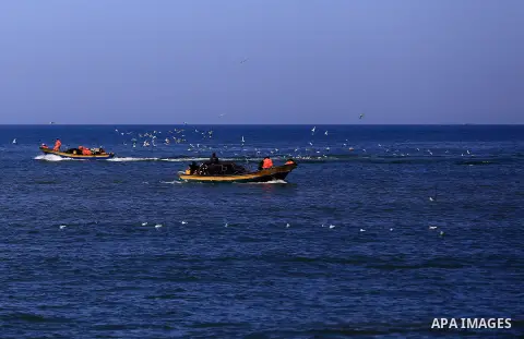 Palestinian fishermen ride their fishing at Gaza's seaport of Gaza City, on March 5, 2016. Photo by Yasser Qudih