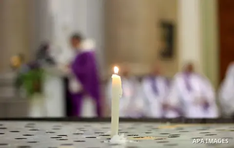 Clergymen pray before the altar in memory of Italian PhD student Guilio Regeni, who was tortured and killed in the capital in January, at Saint Joseph's Roman Catholic Church in Cairo, Egypt March 5, 2016. Photo by Amr S...