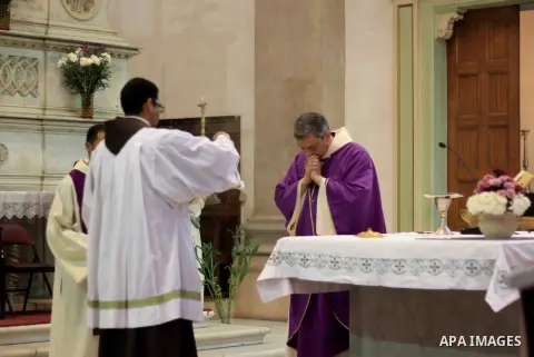 Clergymen pray before the altar in memory of Italian PhD student Guilio Regeni, who was tortured and killed in the capital in January, at Saint Joseph's Roman Catholic Church in Cairo, Egypt March 5, 2016. Photo by Amr S...