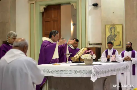 Clergymen pray before the altar in memory of Italian PhD student Guilio Regeni, who was tortured and killed in the capital in January, at Saint Joseph's Roman Catholic Church in Cairo, Egypt March 5, 2016. Photo by Amr S...