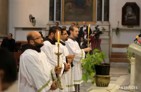Clergymen pray before the altar in memory of Italian PhD student Guilio Regeni, who was tortured and killed in the capital in January, at Saint Joseph's Roman Catholic Church in Cairo, Egypt March 5, 2016. Photo by Amr S...