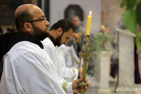 Clergymen pray before the altar in memory of Italian PhD student Guilio Regeni, who was tortured and killed in the capital in January, at Saint Joseph's Roman Catholic Church in Cairo, Egypt March 5, 2016. Photo by Amr S...