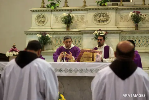 Clergymen kneel before the altar in memory of Italian PhD student Guilio Regeni, who was tortured and killed in the capital in January, at Saint Joseph's Roman Catholic Church in Cairo, Egypt March 5, 2016. Photo by Amr...