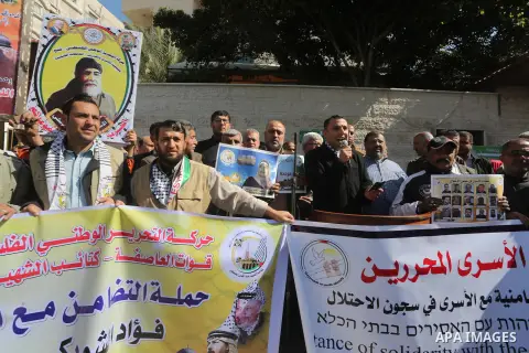 Palestinians take part in a protest demanding release the prisoners in Israeli jails, in front of Red cross office, in Gaza city, on March 7, 2016. Photo by Mohammed Asad