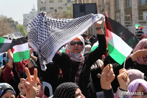 Palestinian women take part in a march in front of the headquarters of the Red cross on the occasion of International Women's Day in Gaza City on March 7, 2016. Photo by Mohammed Asad