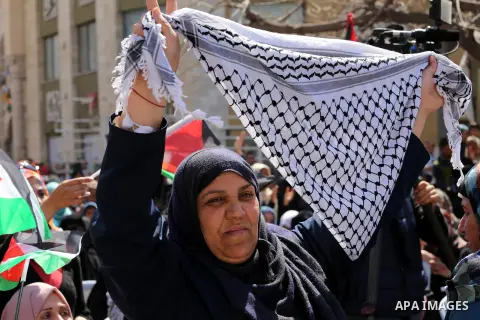 Palestinian women take part in a march in front of the headquarters of the Red cross on the occasion of International Women's Day in Gaza City on March 7, 2016. Photo by Mohammed Asad