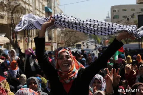 Palestinian women take part in a march in front of the headquarters of the Red cross on the occasion of International Women's Day in Gaza City on March 7, 2016. Photo by Mohammed Asad