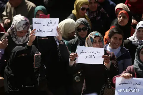 Palestinian teachers take part in a protest to demand their rights in front of the headquarters of the Council of Ministers, in the West bank city of Ramallah, March7, 2016. Photo by Shadi Hatem