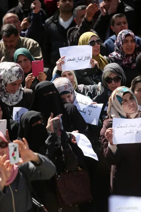 Palestinian teachers take part in a protest to demand their rights in front of the headquarters of the Council of Ministers, in the West bank city of Ramallah, March7, 2016. Photo by Shadi Hatem