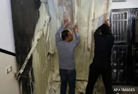 Palestinians check the damage house of Ibrahim Skafi that was demolished by the Israeli army in the West Bank city of Hebron March 8, 2016. Skafi was shot dead after he rammed an Israeli soldiers in Halhul north of Hebro...