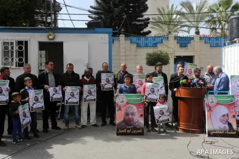 Palestinians hold placards during a protest in solidarity with Palestinian prisoners in Israeli jails, in front of high commissioner for human rights headquarters, in Gaza City on March 9, 2016. Photo by Mohammed Asad