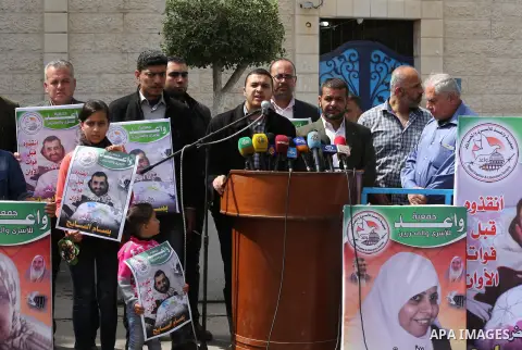 Palestinians hold placards during a protest in solidarity with Palestinian prisoners in Israeli jails, in front of high commissioner for human rights headquarters, in Gaza City on March 9, 2016. Photo by Mohammed Asad