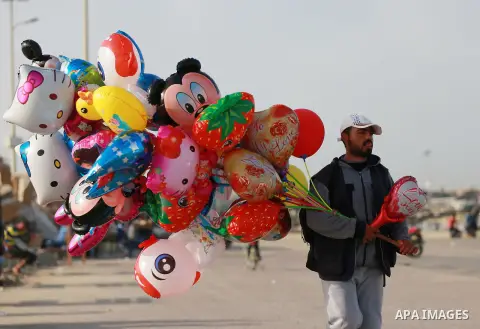 Palestinian man sells balloons at the beach of the Mediterranean sea on the coast of Gaza city, on March 09, 2016. Photo by Yasser Qudih