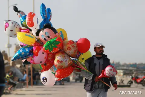 Palestinian man sells balloons at the beach of the Mediterranean sea on the coast of Gaza city, on March 09, 2016. Photo by Yasser Qudih