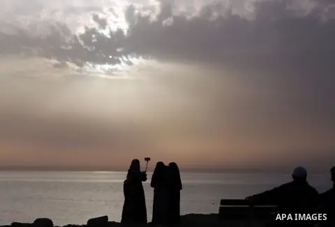 Palestinian women take a selife at the beach of the Mediterranean sea on the coast of Gaza city, on March 09, 2016. Photo by Yasser Qudih