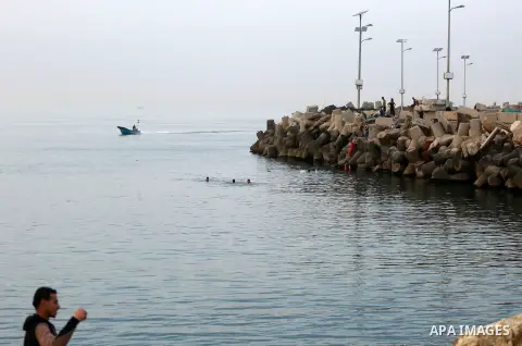 Palestininas dive into the Mediterranean Sea on the coast of Gaza City on March 09, 2016. Photo by Yasser Qudih