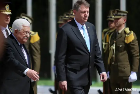Romanian President Klaus Iohannis reviews honor guard with Palestinian president Mahmoud Abbas upon his arrival to the West Bank city of Ramallah on March 10, 2016. Photo by Shadi Hatem