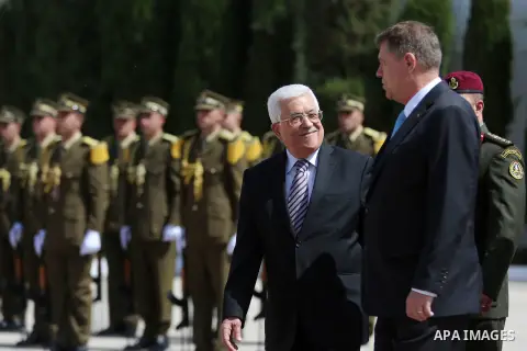 Romanian President Klaus Iohannis reviews honor guard with Palestinian president Mahmoud Abbas upon his arrival to the West Bank city of Ramallah on March 10, 2016. Photo by Shadi Hatem