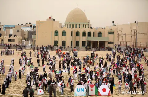 Palestinian children fly kites to show their solidarity with the Japanese people near the Japan-funded housing project in Khan Younis in the southern Gaza Strip March 13, 2016. The event was organised by the United Natio...