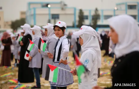 Palestinian children fly kites to show their solidarity with the Japanese people near the Japan-funded housing project in Khan Younis in the southern Gaza Strip March 13, 2016. The event was organised by the United Natio...