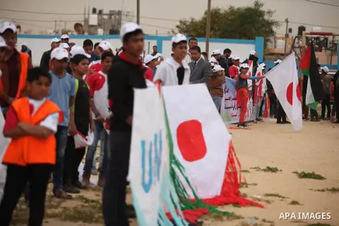 Palestinian children fly kites to show their solidarity with the Japanese people near the Japan-funded housing project in Khan Younis in the southern Gaza Strip March 13, 2016. The event was organised by the United Natio...