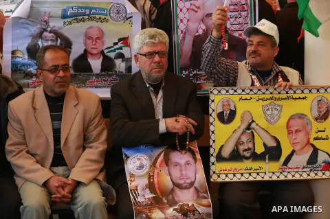 Palestinians take part in a protest demanding release the prisoners in Israeli jails, in front of Red cross office, in Gaza city, on March 14, 2016. Photo by Yasser Qudih