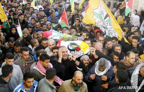 Mourners carry the body of Palestinian Yousef Tarayra, 18, who the Israeli military said was shot dead by the Israeli army after he carried out an attack on Israelis, during his funeral in the West Bank village of Bani N...