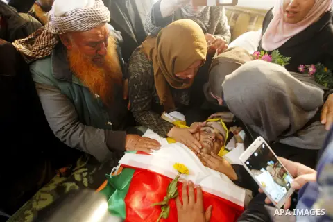 Relatives of Palestinian Yousef Tarayra, 18, who the Israeli military said was shot dead by the Israeli army after he carried out an attack on Israelis, mourn during his funeral in the West Bank village of Bani Na'im nea...