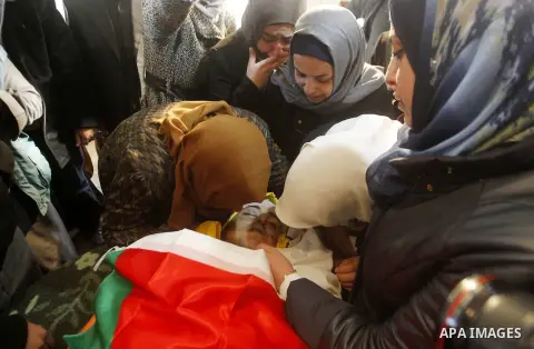 Relatives of Palestinian Yousef Tarayra, 18, who the Israeli military said was shot dead by the Israeli army after he carried out an attack on Israelis, mourn during his funeral in the West Bank village of Bani Na'im nea...